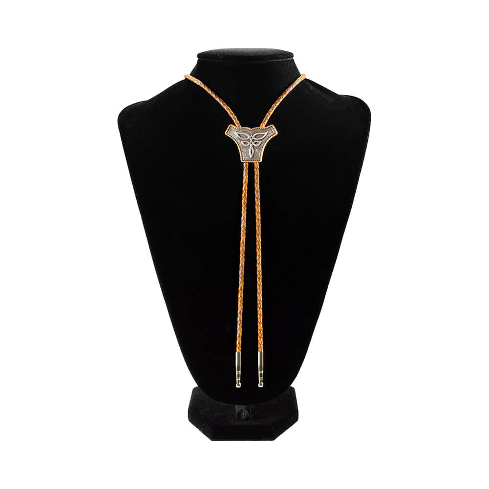 A bolo tie with a silver-toned scalloped pendant on brown cord, displayed on a black velvet mannequin bust against a white background.