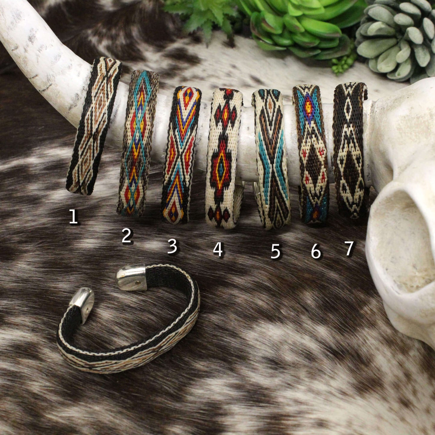 Vibrant colors and elaborate designs highlight these hitched horsehair cuff bracelets. These flexible bracelets will be the envy of all your friends. Flower etched silver ends add the finishing touch to these beautiful pieces. Order by color. Approximately 7" long. Patterns and colors vary slightly.