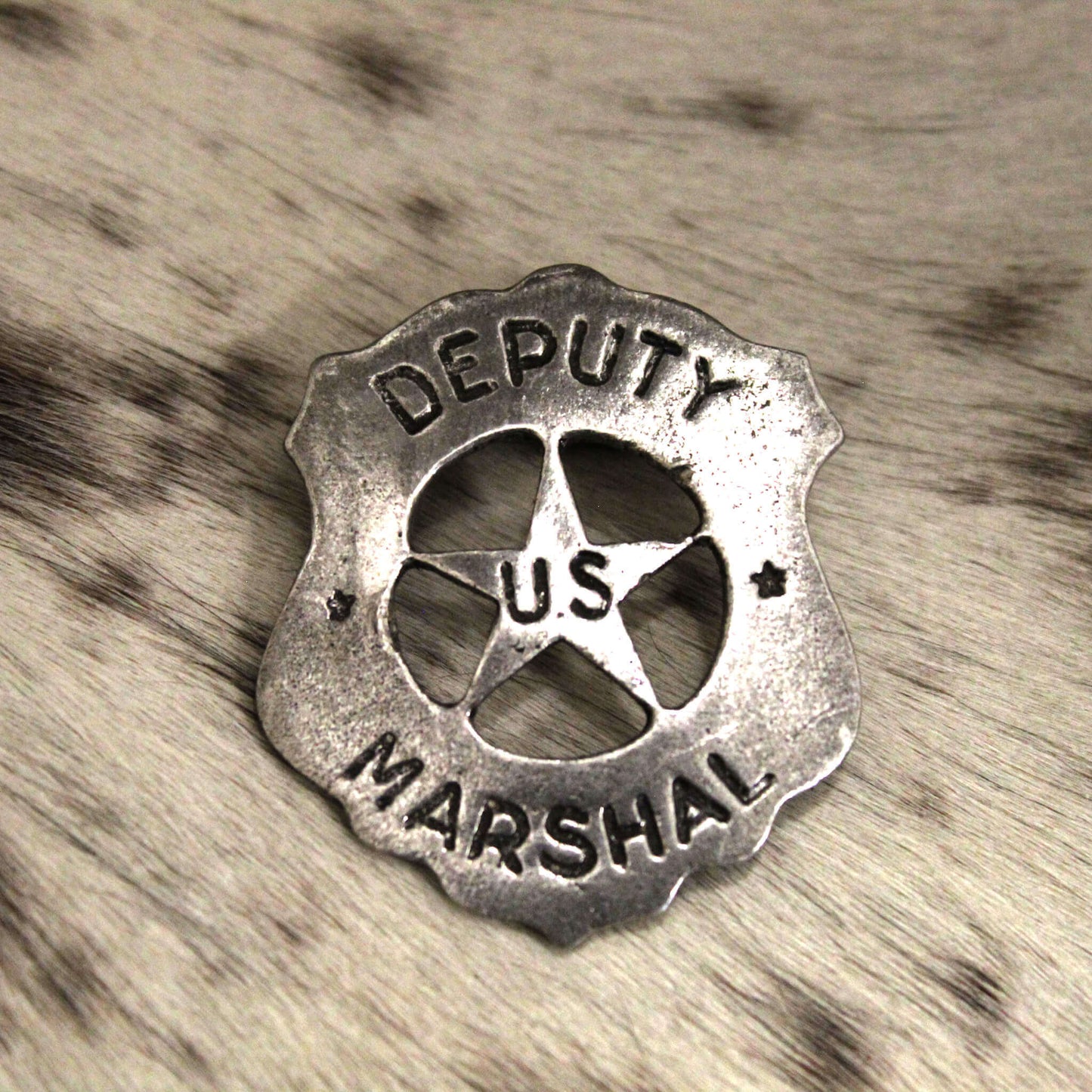 This type of badge was worn by the infamous Earp brothers, Wyatt and Virgil. This is also the type of badge worn by James Arness as Matt Dillon in the television series Gunsmoke. Made just like those from the past. Cast pewter with awesome detail. Antique silver finish. Measures 2 5/8" tall by 2 1/8" wide. Comes displayed in an old west card. Proudly made in the USA.