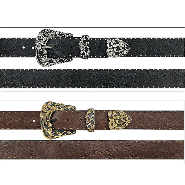 Two western-style belts shown horizontally on a white background: one black tooled belt with silver buckle and keeper, and one brown tooled belt with gold-tone buckle and keeper.