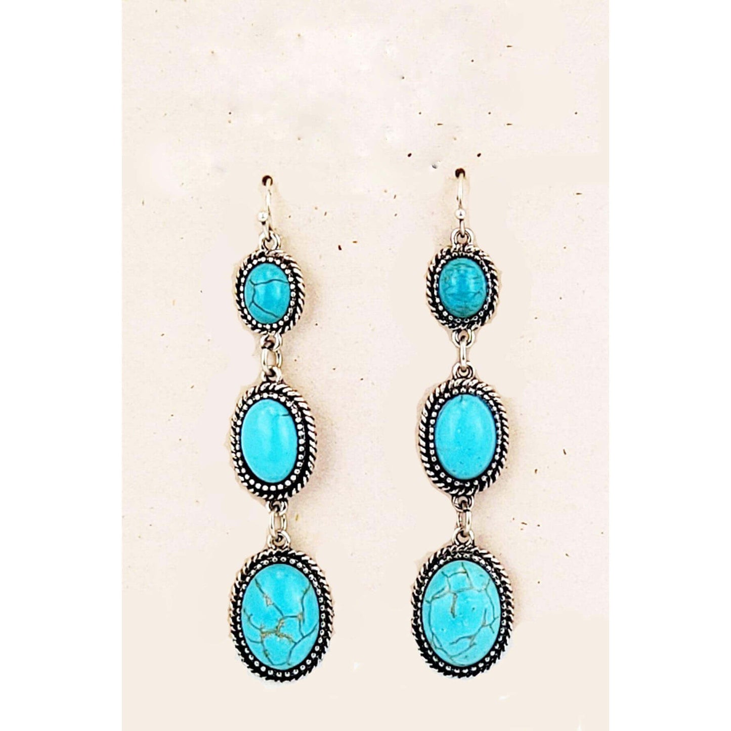 These long 3 Turquoise stone earrings are perfect for any occasion. The hypoallergenic ear wire holds 3 gradually increasing Turquoise stones. These earrings are ready for your night out. Measures 3″ from bottom of ear wire (1″ stones) to bottom of earring.