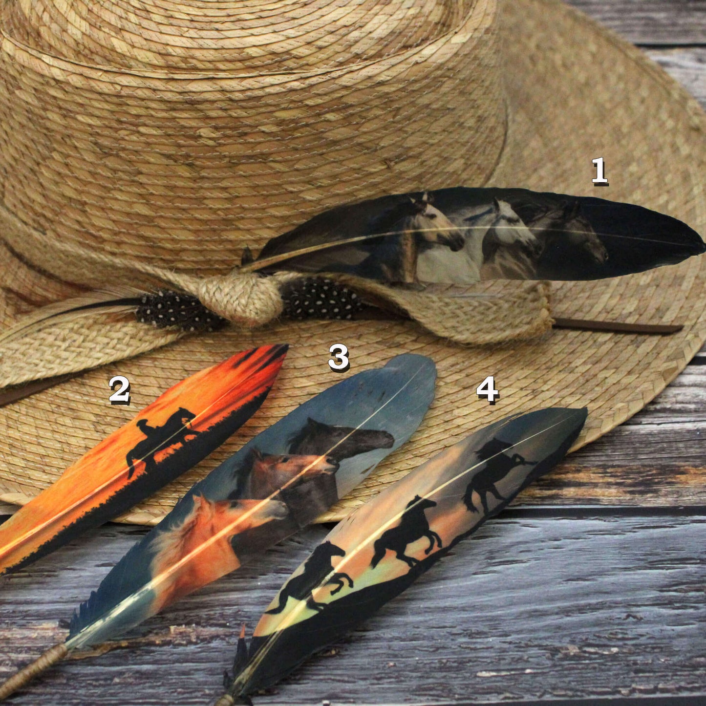 A collection of four decorative hat feathers with horse patterns, displayed on a straw hat.