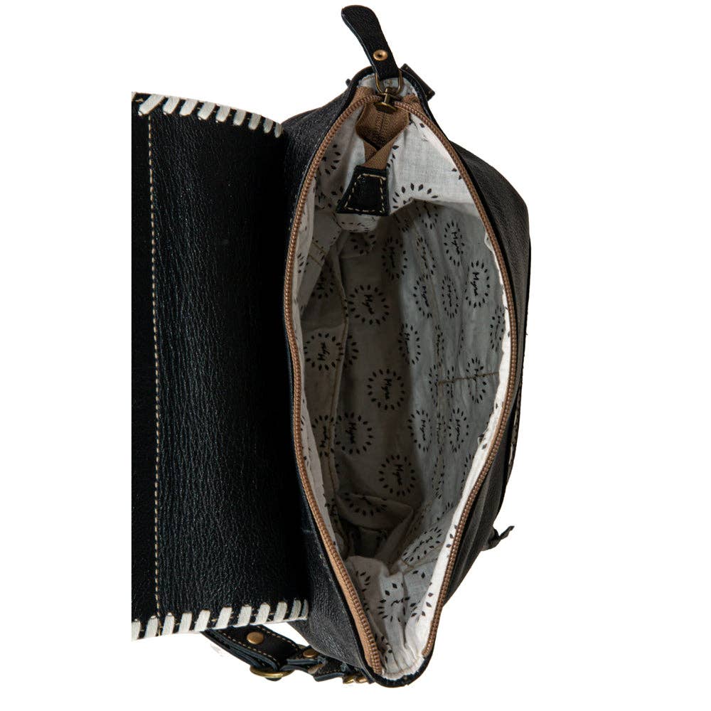 Black leather bag with a patterned interior on a white background