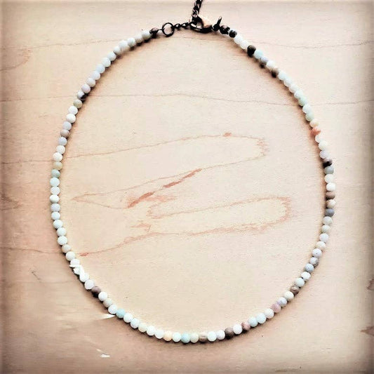 Necklace with small beads on a wooden surface