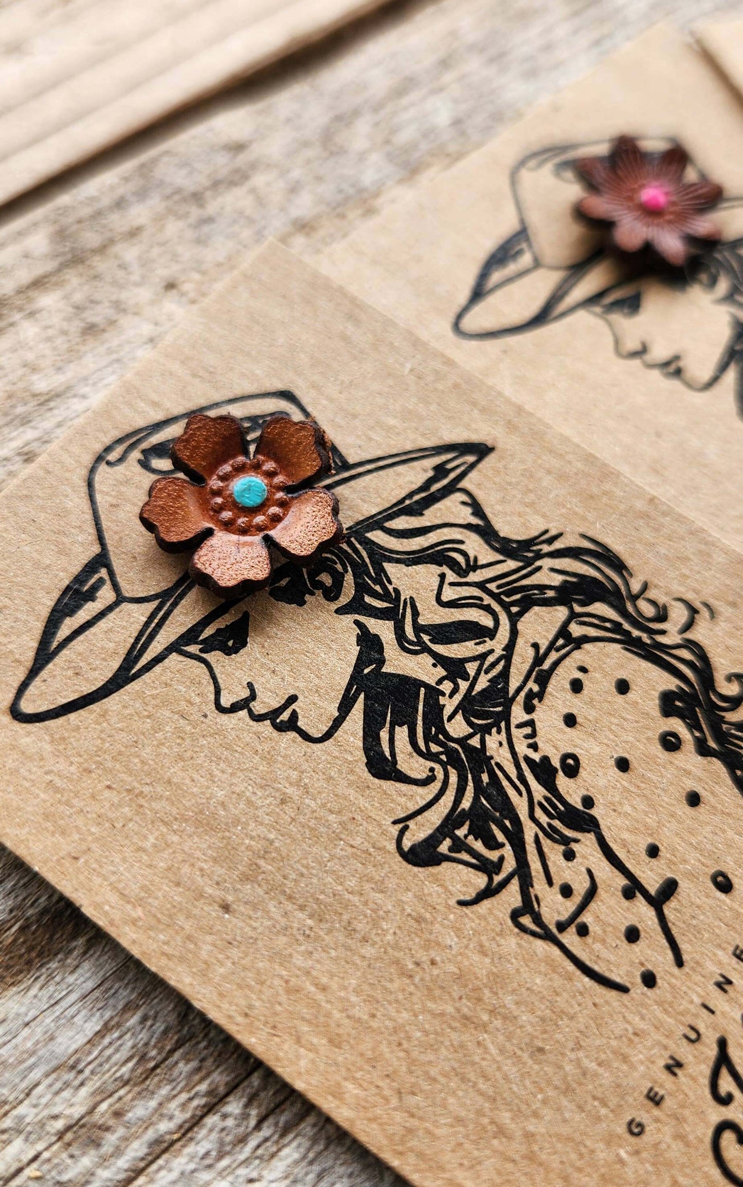 Decorative Leather Hat Pin floral design on a wooden surface