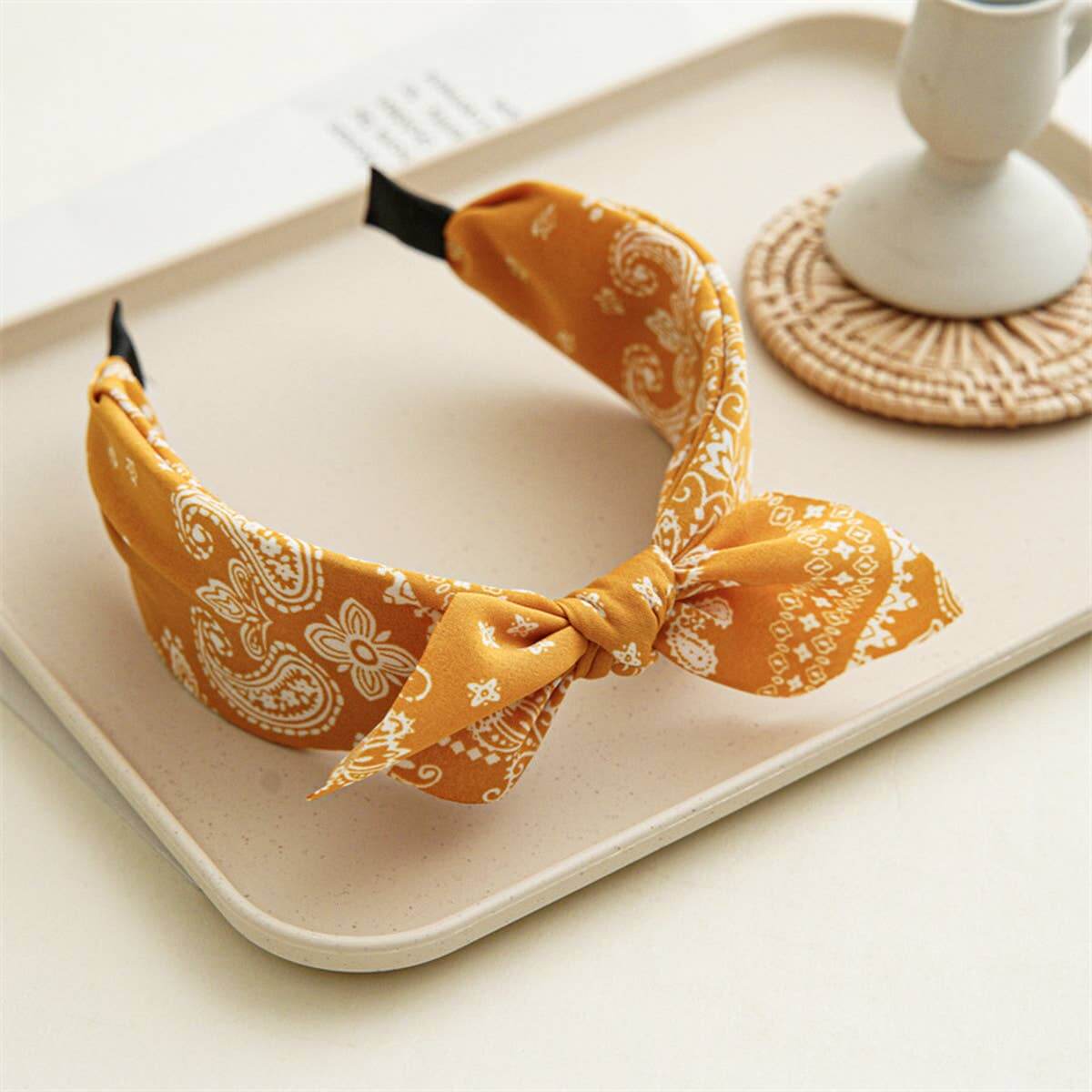 Bandana Bow Headbands displayed on a tray with a charming bow and bandana print design.