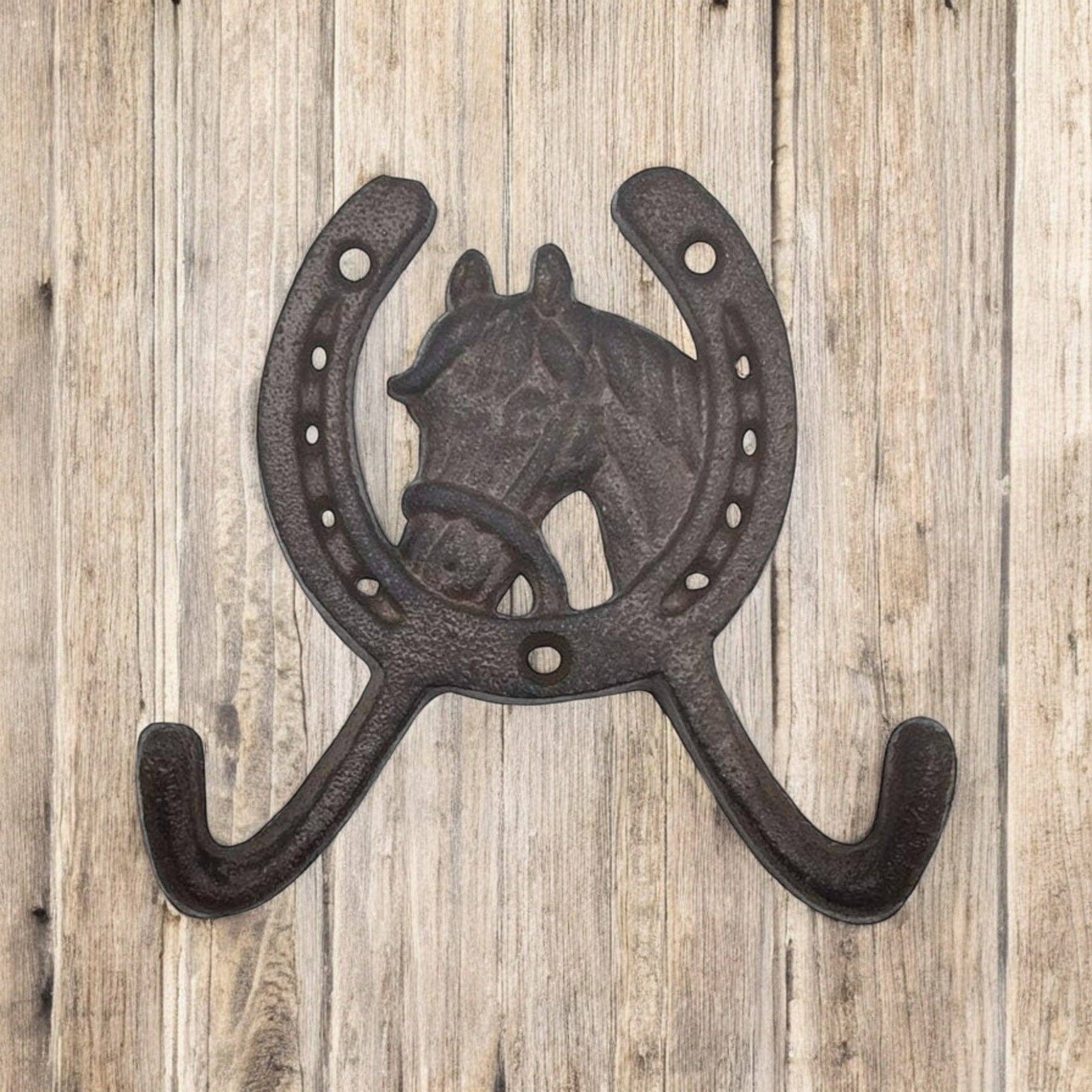 Decorative wall hook with horse design on a wooden background