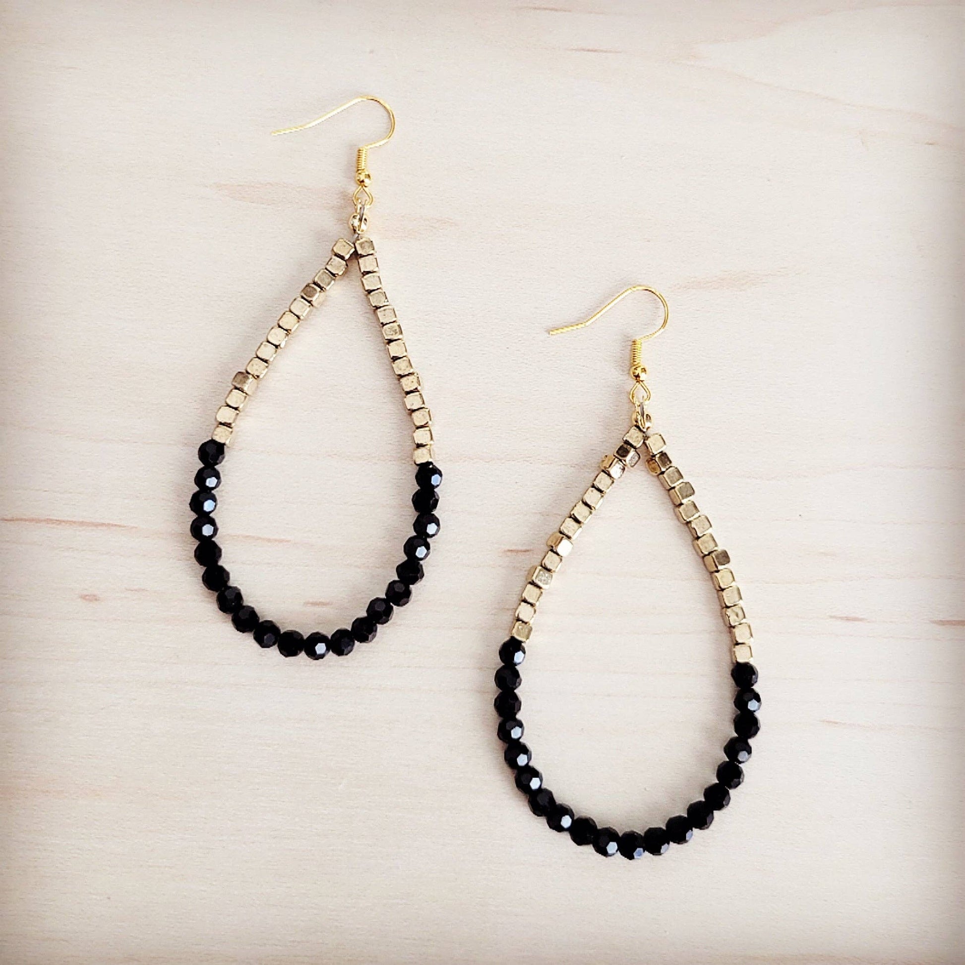 Pair of beaded earrings on a light wooden surface