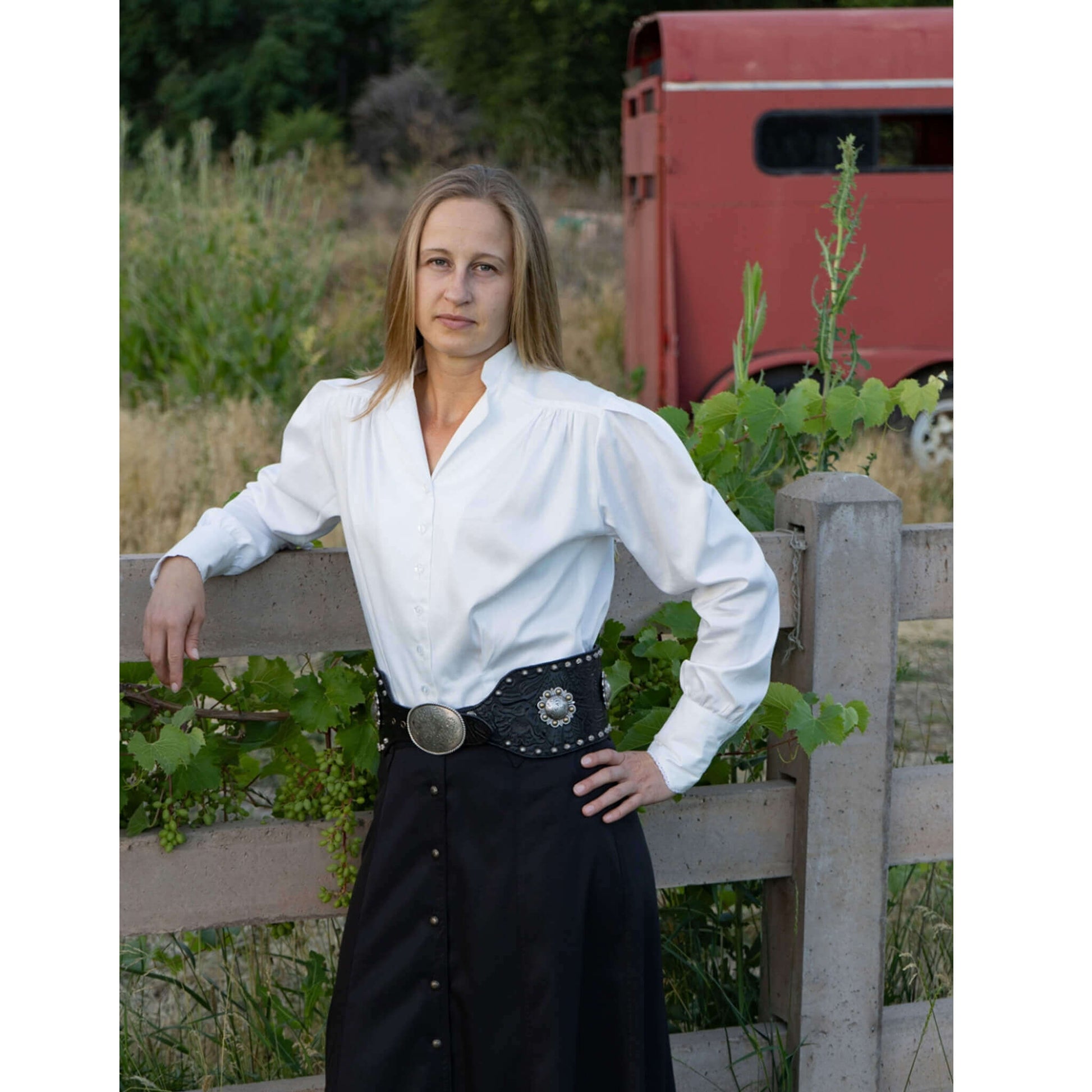 Model wearing a Belle Western Victorian Blouse with feminine fit and lace-trimmed cuffs, styled casually outdoors.