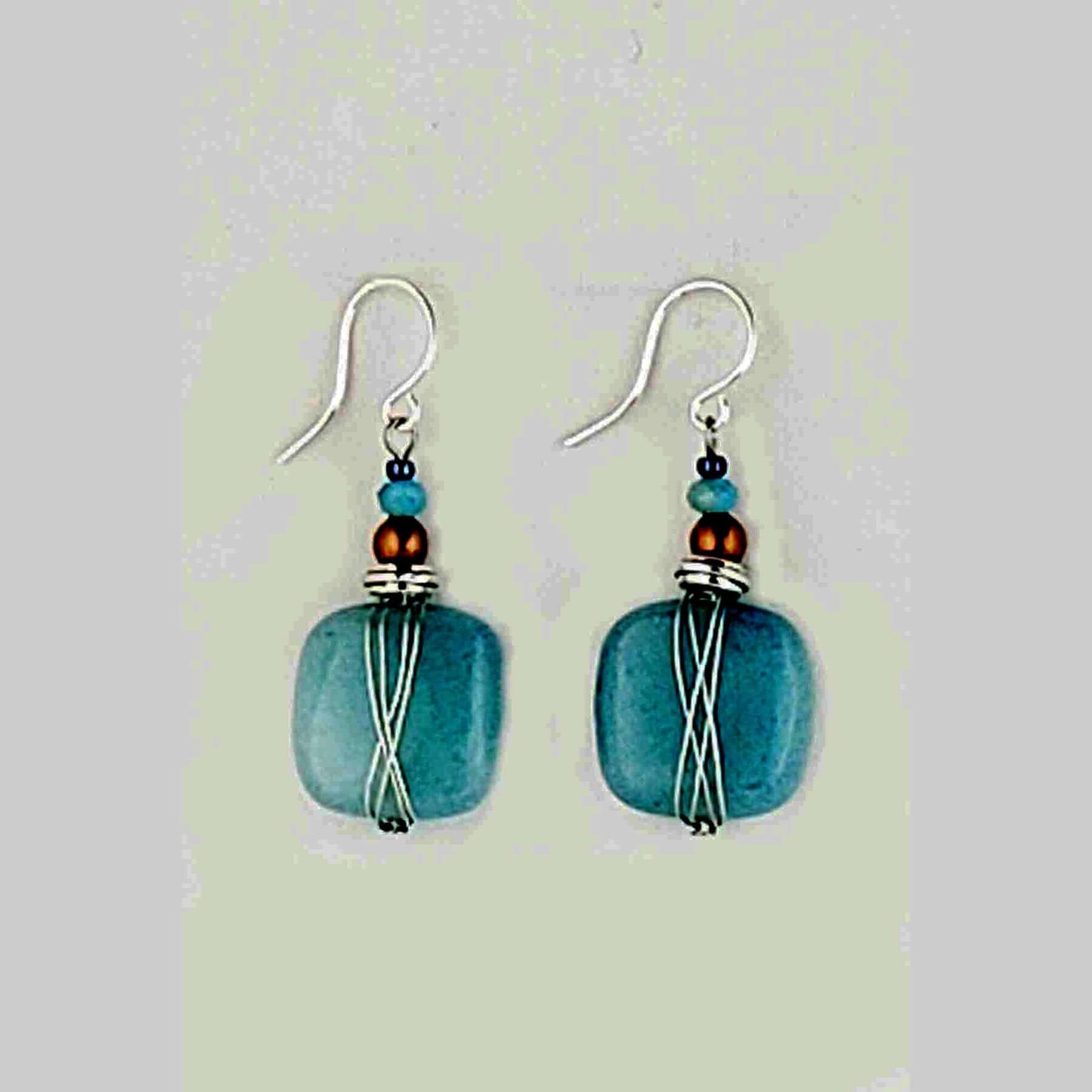 Harness the power of blue quartz to stimulate your imagination and free your mind. These earrings are the perfect accessory for artists, writers, and anyone seeking a boost of creative inspiration. Wear them daily to tap into your inner wellspring of ideas and bring your visions to life. Measures approx. .5" wide and 1″ from the base of hypo-allergenic ear wires. Each pair has its own unique features and the story of its properties on the card. Made in USA