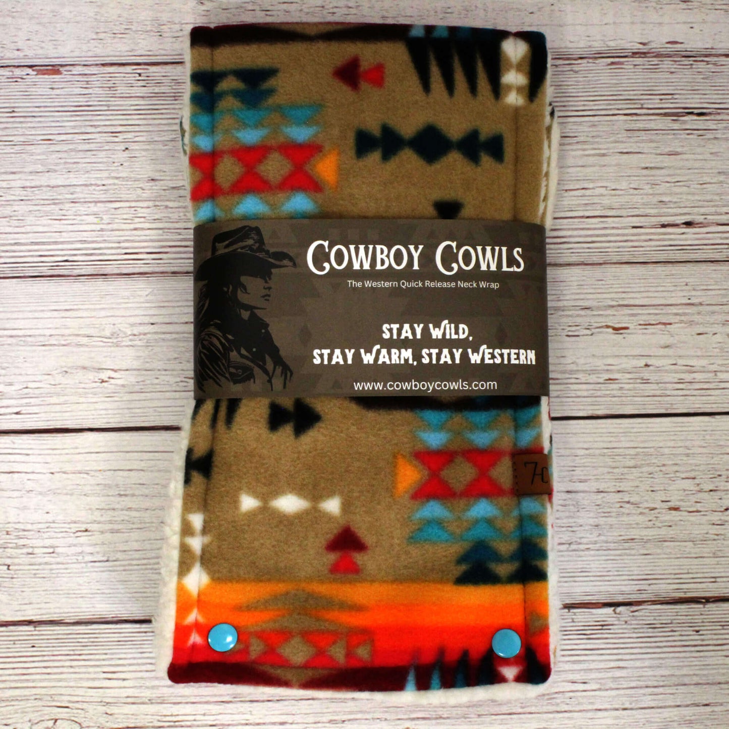 Cowboy Cowls neck wrap with colorful pattern on a wooden surface