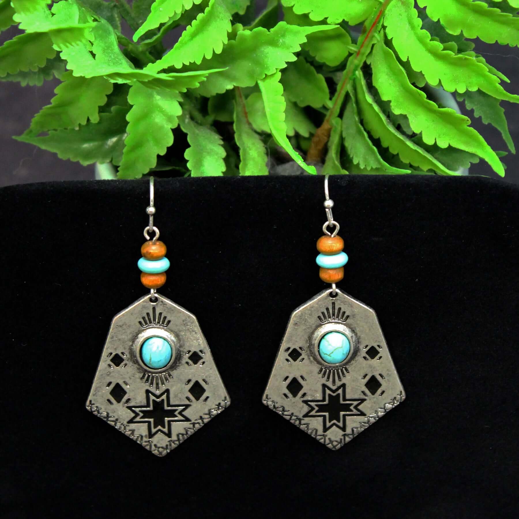 Embrace your adventurous spirit and let these Cowgirl Adventure Earrings transport you to the wide-open landscapes of the American West. Whether you're headed to a music festival, a night out with friends, or just running errands, these earrings will add an effortless touch of style and flair to any outfit. Prepare to turn heads and start conversations wherever your cowgirl adventures take you. Measure 2-1/2" long and 1-1/8" at widest point.