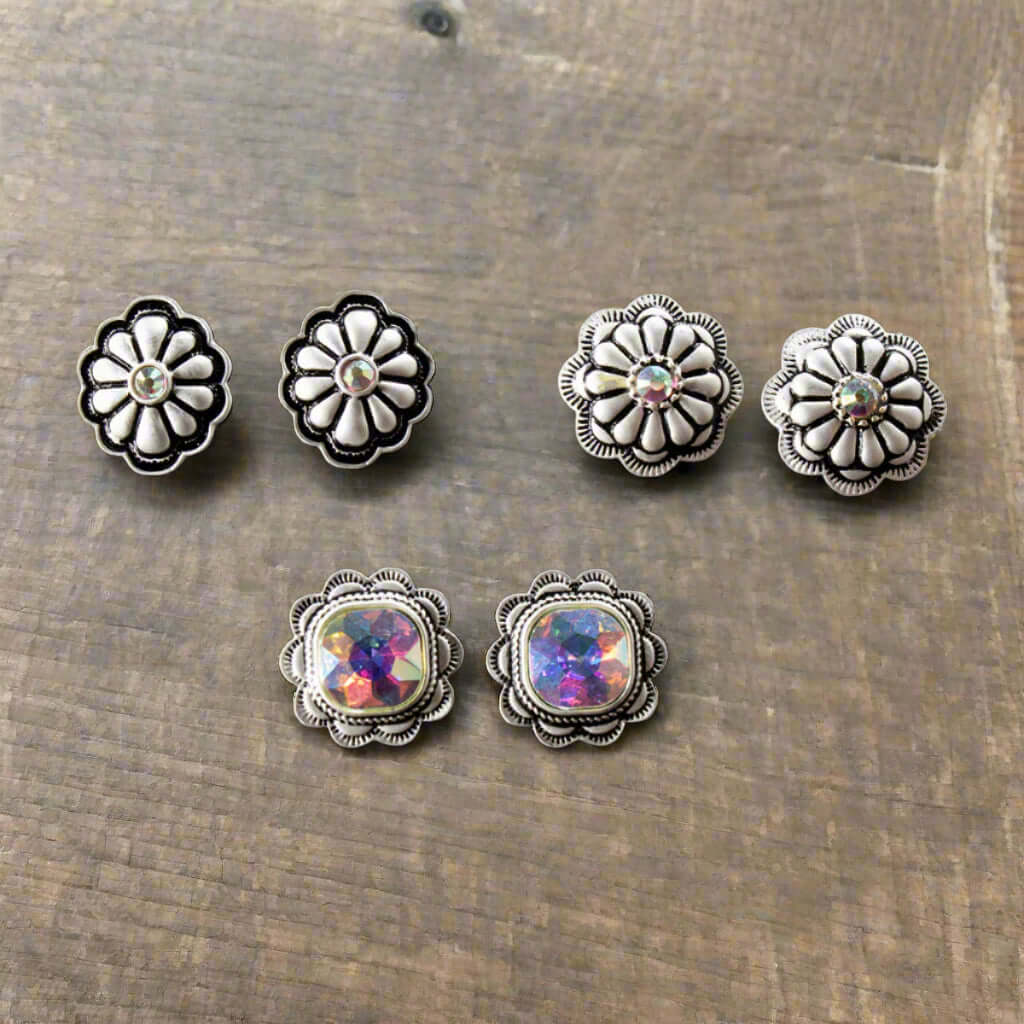 Each earring showcases a stunning aurora borealis crystal at its center, capturing light and adding a touch of sparkle to any outfit. Designed as post-style earrings, measuring 3/4", these earrings are the ideal size. Embrace your inner cowgirl with this stylish and versatile set that effortlessly combines elegance and western flair. Made in China.