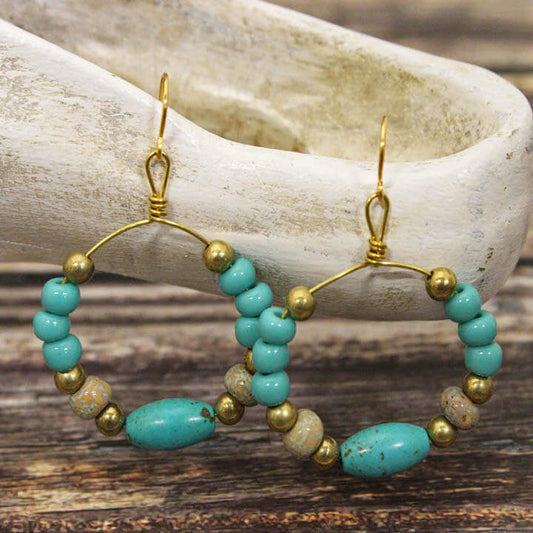 Crafted with a delicate gold wire hoop and adorned with exquisite Magnesium Turquoise, these earrings measure approximately 1″ in diameter from the base of the hypoallergenic ear wires, ensuring comfort for all-day wear. Handcrafted in the USA.