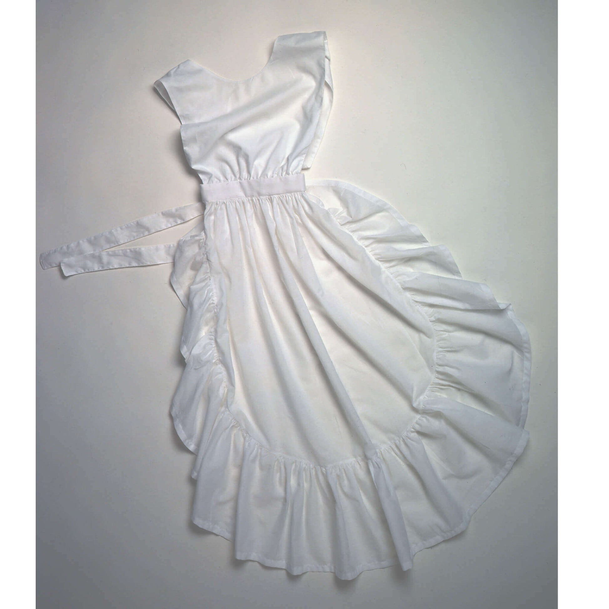 White cotton chicken feeding country apron with ruffled hem and adjustable back tie, made in USA.
