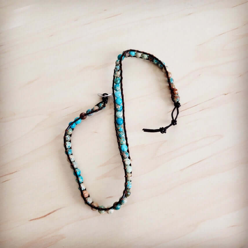 Bracelet with beads on a light wooden surface