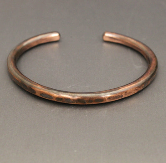 Copper bracelet on a gray background