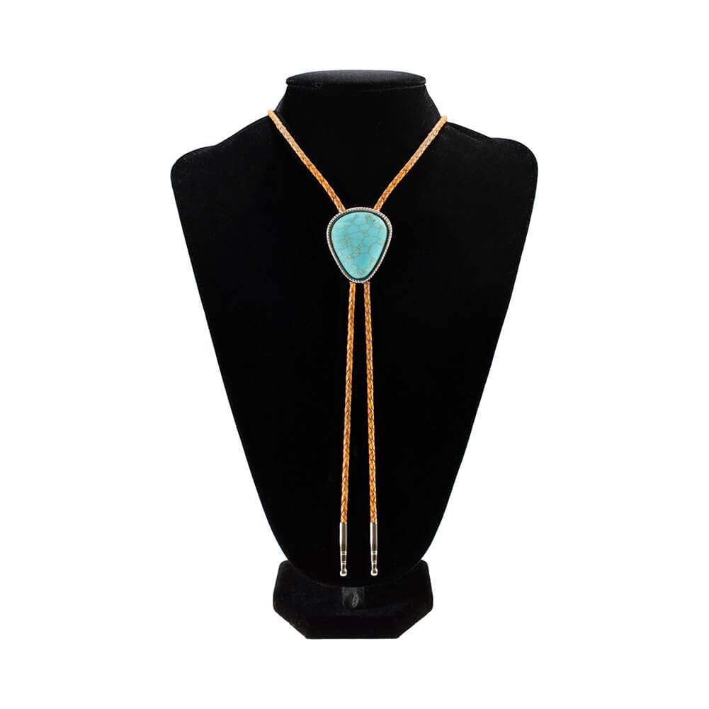 A turquoise bolo tie necklace with leather brown cord and silver-toned metal accents, displayed on a black velvet mannequin bust against a white background.