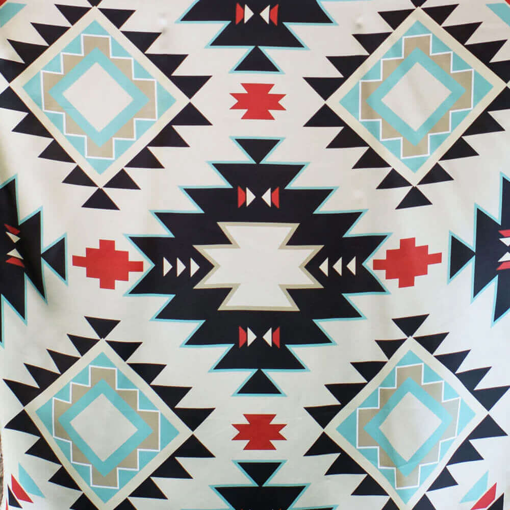 Patterned fabric with geometric design featuring triangles, diamonds, and red accents on a white background.