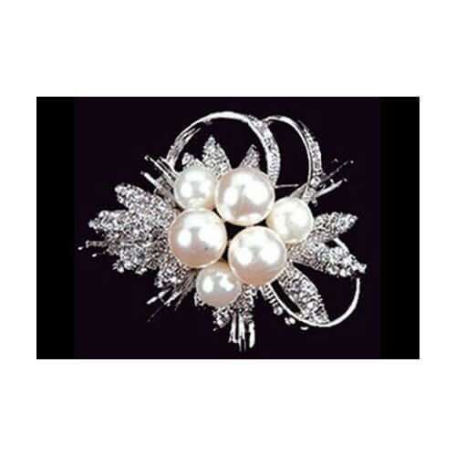 Pearl and crystal brooch on a black background