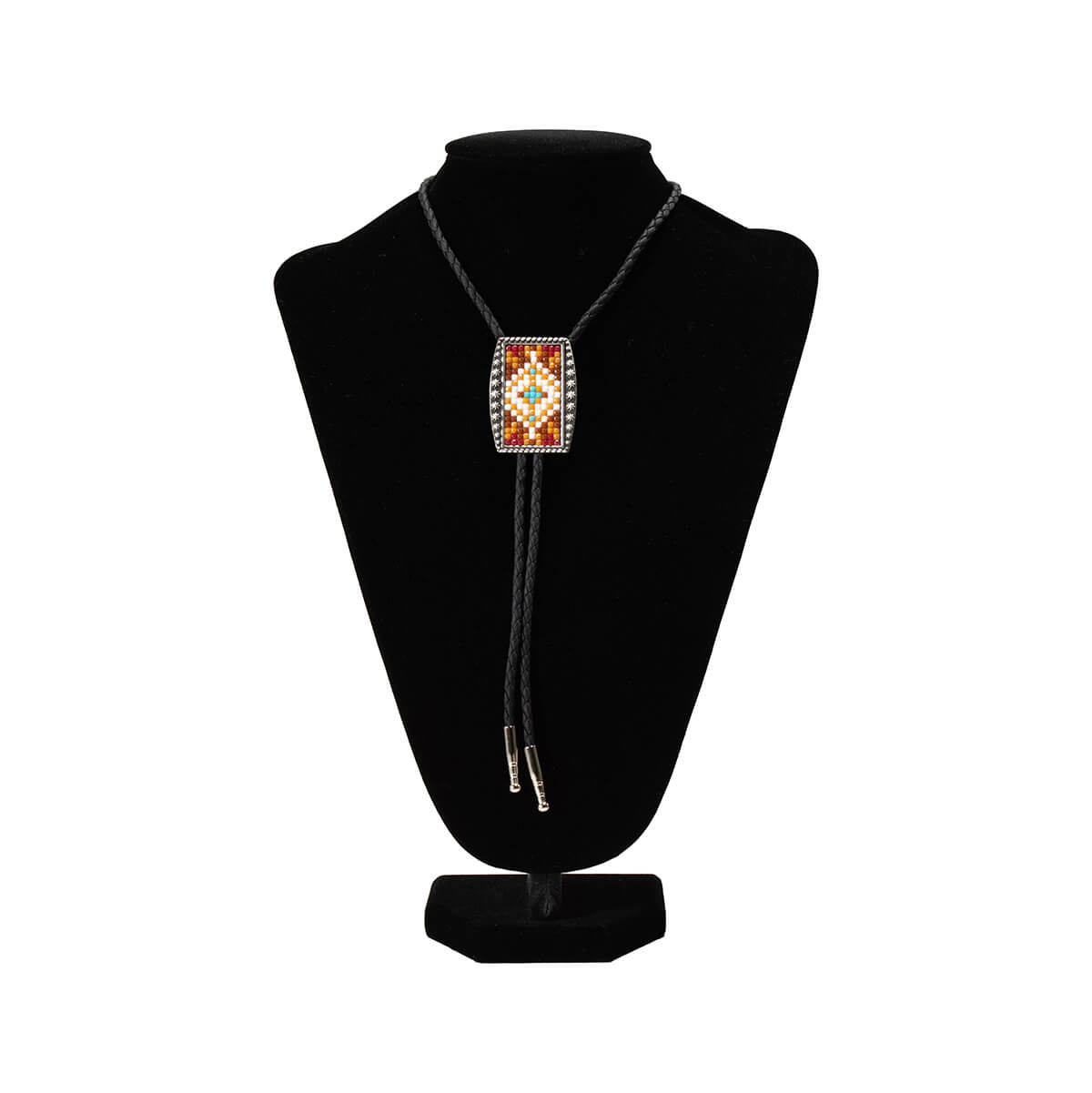 A beaded bolo tie necklace displayed on a black velvet mannequin bust against a white background. The necklace features a rectangular front panel with a Southwestern-style geometric pattern in red, orange, yellow, and white, bordered by small silver beads.