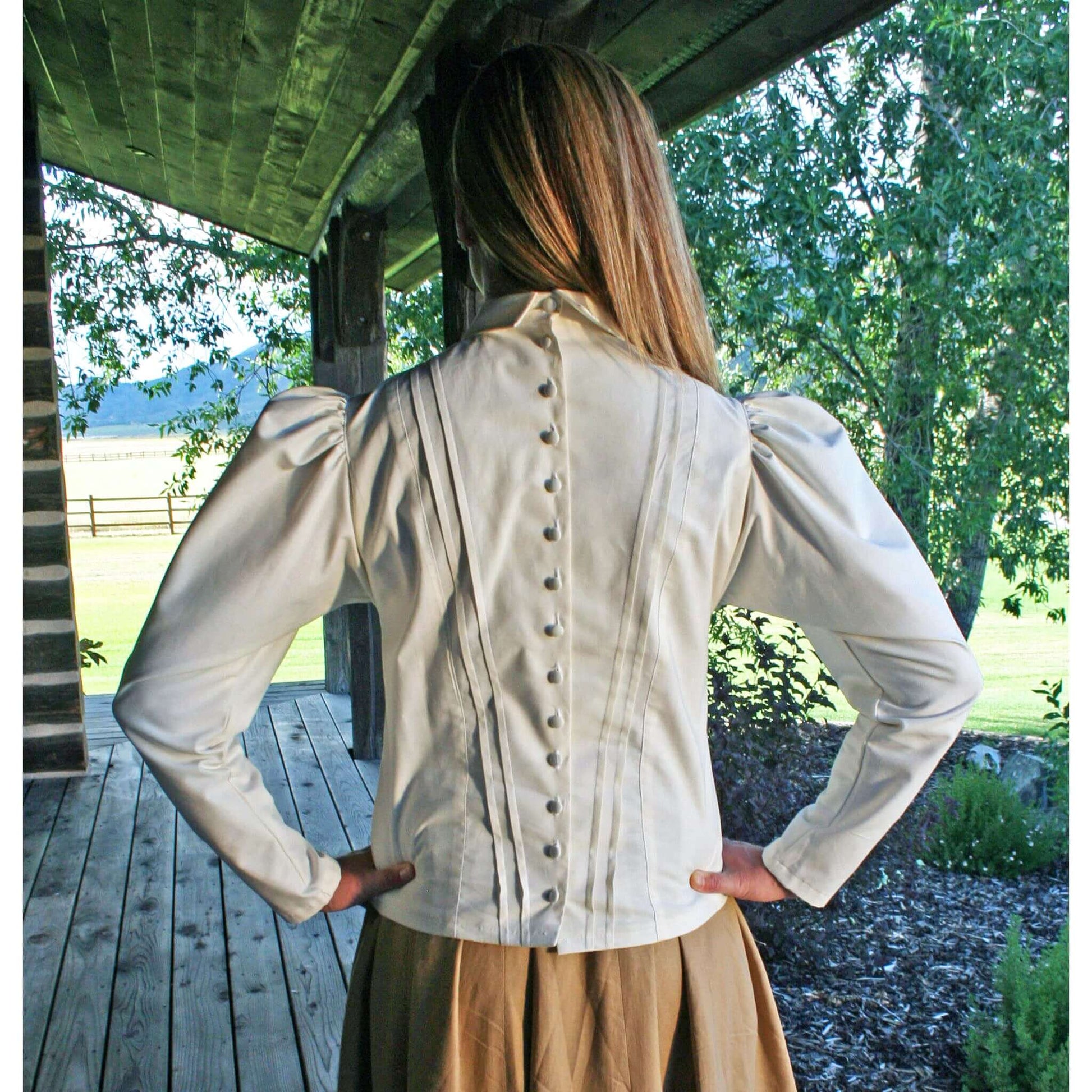 Back view of a Schoolmarm Country Blouse showcasing puffed sleeves and buttoned design.