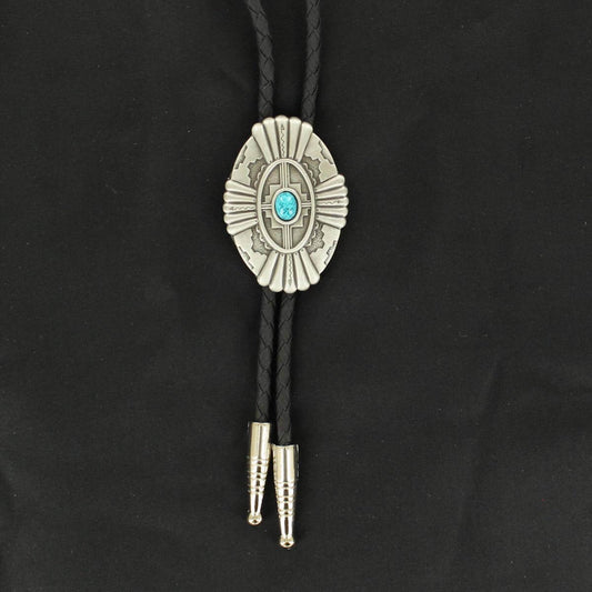 A bolo tie with a silver-colored concho featuring an oval turquoise stone, black braided strings, and silver tips.