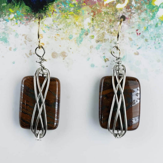 Tiger-eye cabochon. The gold hypoallergenic ear wires extend down to silver wire wrapping around a tiger-eye cabochon. Measures 1″ from bottom of ear wire to bottom of tiger-eye stone.