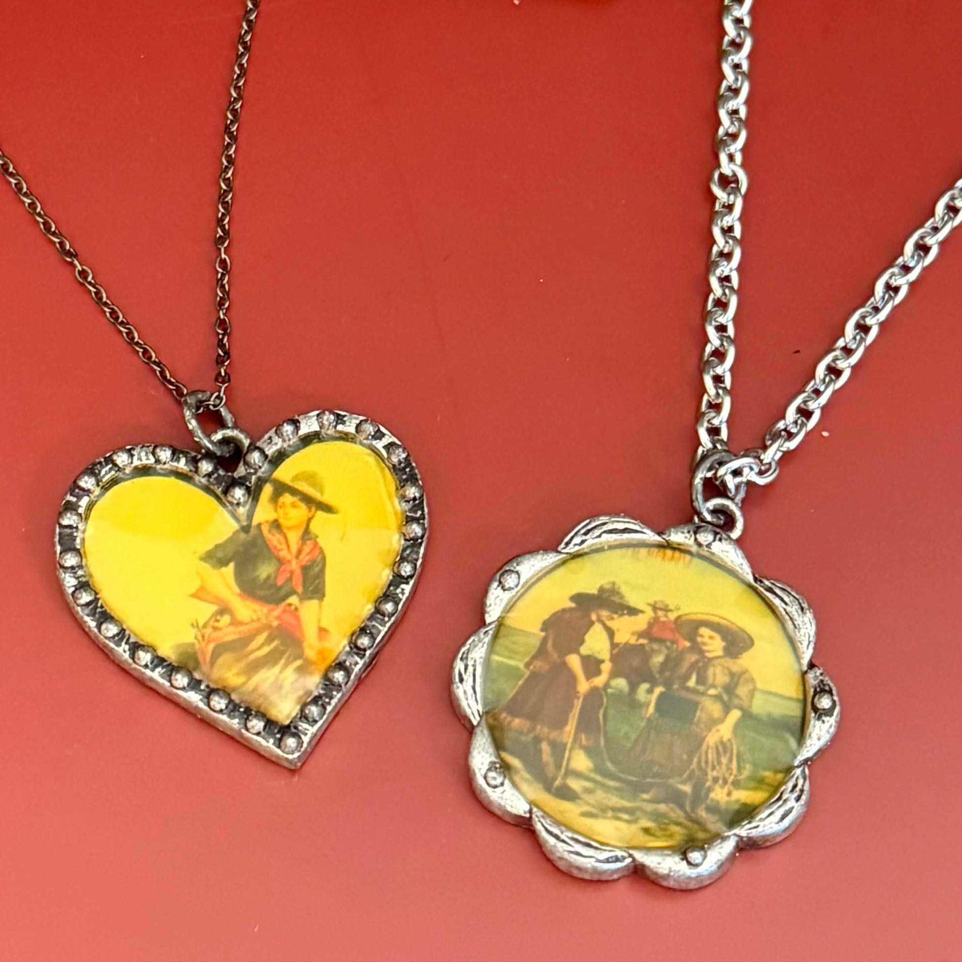 Two necklaces with vintage cowgirl  illustrations on a red background.
