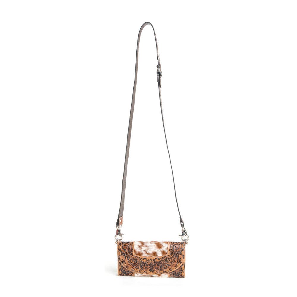 Small crossbody bag with cowhide pattern on a white background