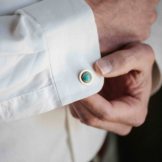 Cufflink with turquoise stone on a white shirt cuff