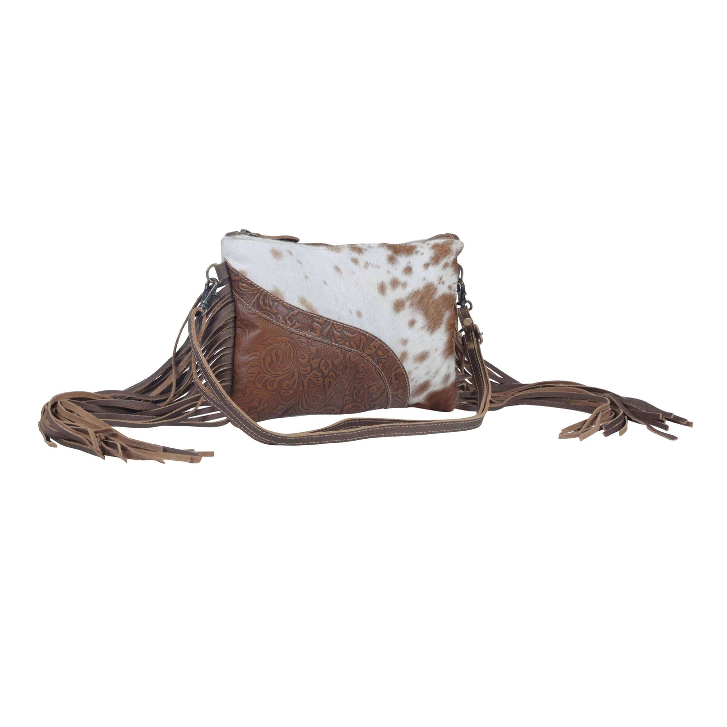 Brown and white cowhide leather crossbody bag with fringes on a white background
