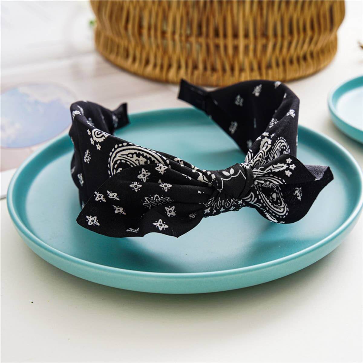 Bandana Bow Headbands on a blue plate, featuring a stylish bandana print and a charming bow design.