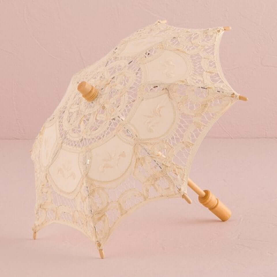 Ladies Western Victorian Lace Parasol in ecru Battenberg lace against a soft pink background.