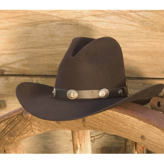 Western Wool Tombstone Cowboy Hat resting on a wooden surface, showcasing its classic design and durable felt material.